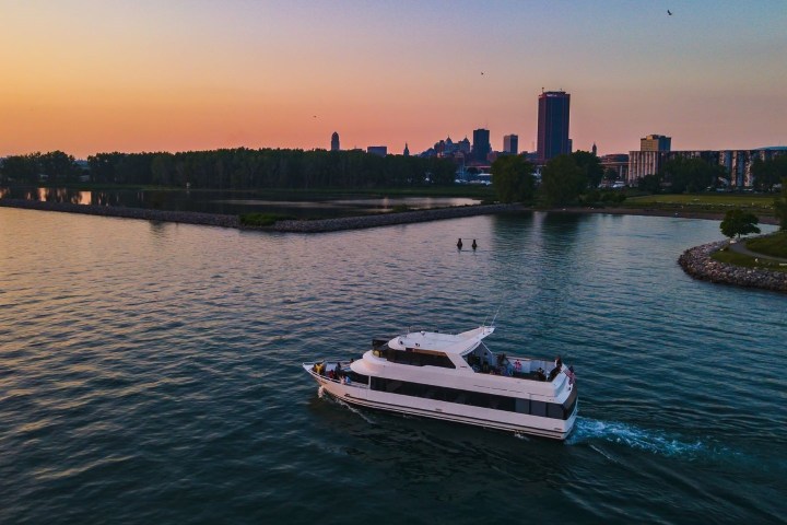 a boat traveling across a bridge over a body of water